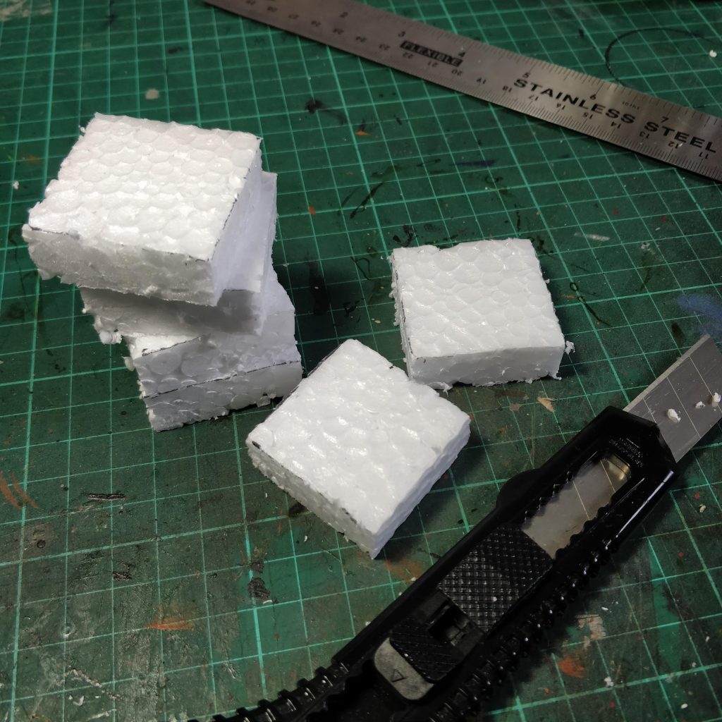 Squares of cut foam next to a retractable knife
