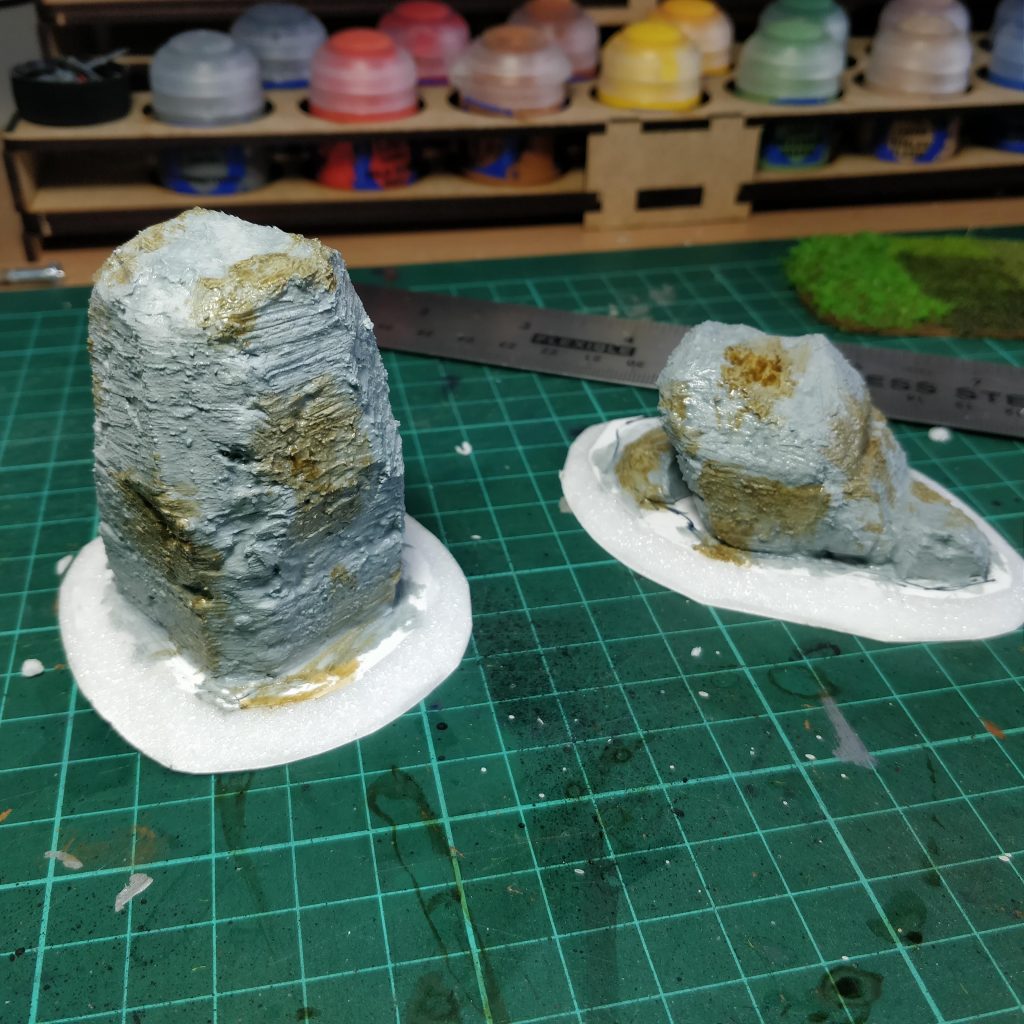 Standing stones with grey and brown paint applied