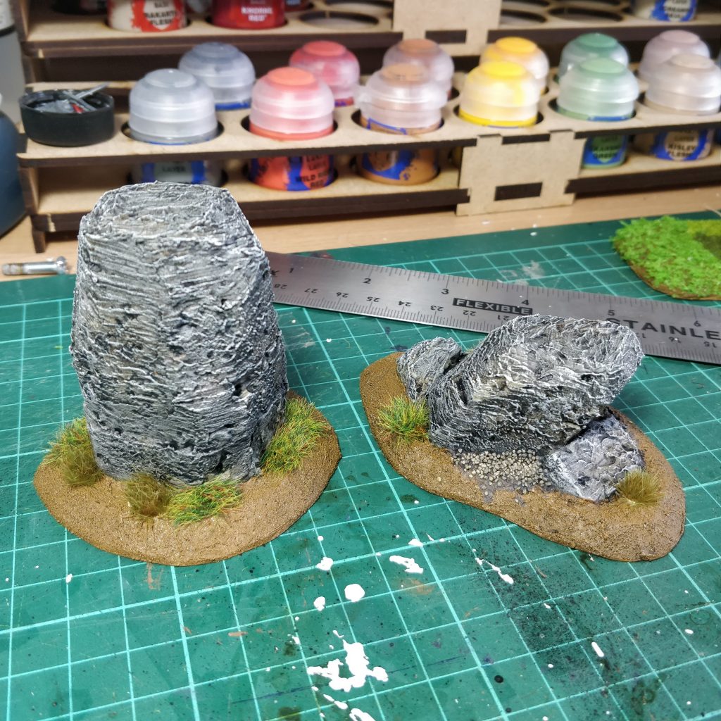 Standing stones with grass tufts applied to their base